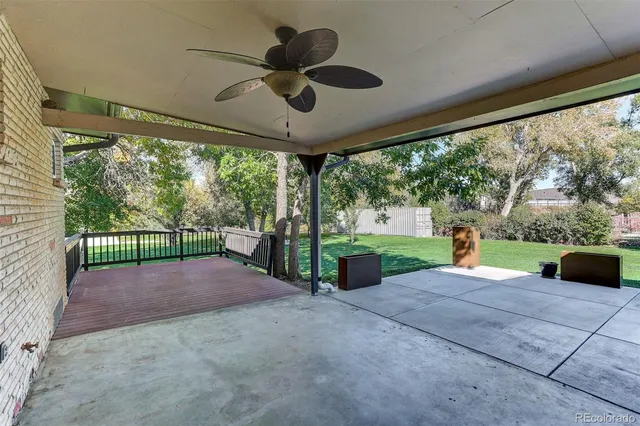 a view of a yard with porch and wooden fence