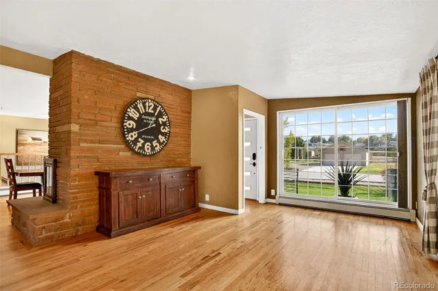 a view of a room with furniture wooden floor and window