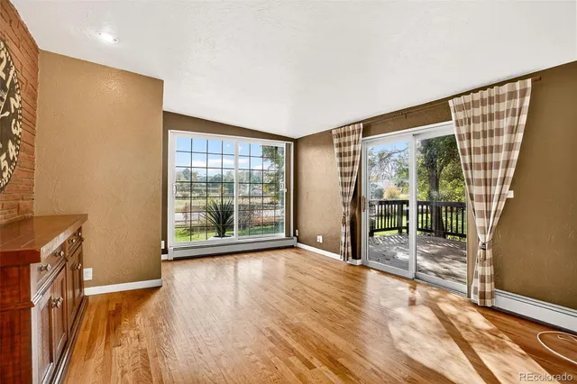 a view of an empty room with glass door