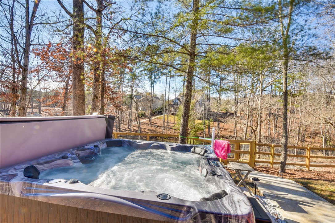 206 Petty Road Seneca, SC 29672 - Photo 37 of 48 Relax in this inviting outdoor spa, nestled among mature trees and offering a tranquil retreat.