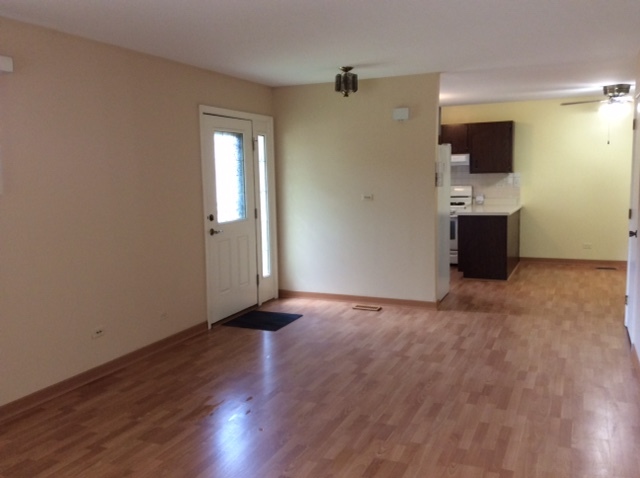 148 Innsbrook Drive Streamwood, IL 60107 - Photo 4 of 19 an empty room with wooden floor and bathroom