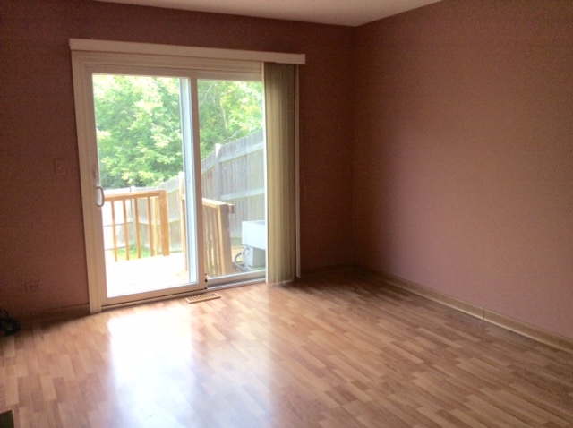 148 Innsbrook Drive Streamwood, IL 60107 - Photo 9 of 19 an empty room with wooden floor and windows