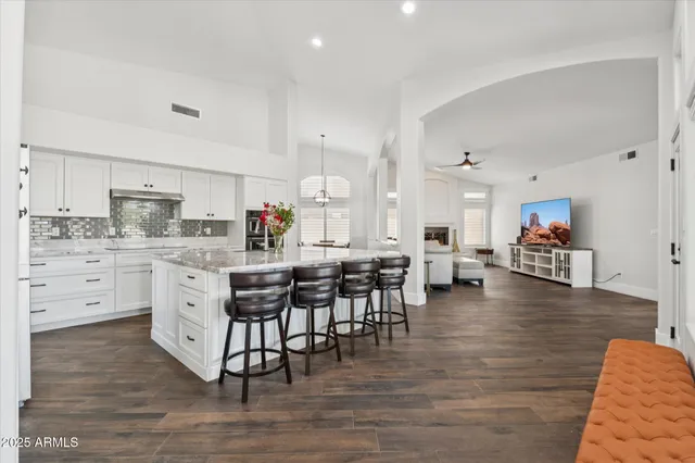 a kitchen with white cabinets and appliances