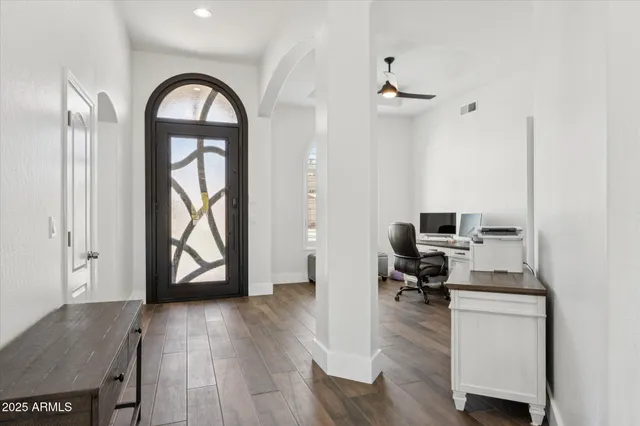 a view of workspace with wooden floor windows cabinet and couch