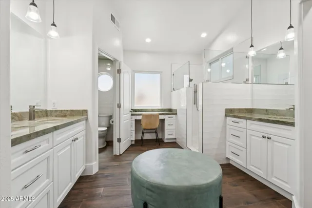 a spacious bathroom with a granite countertop sink mirror and toilet