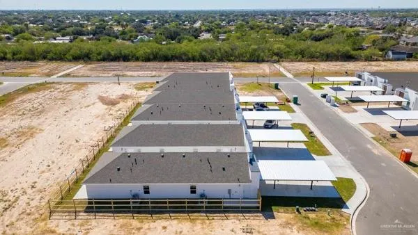 an aerial view of residential houses with outdoor space