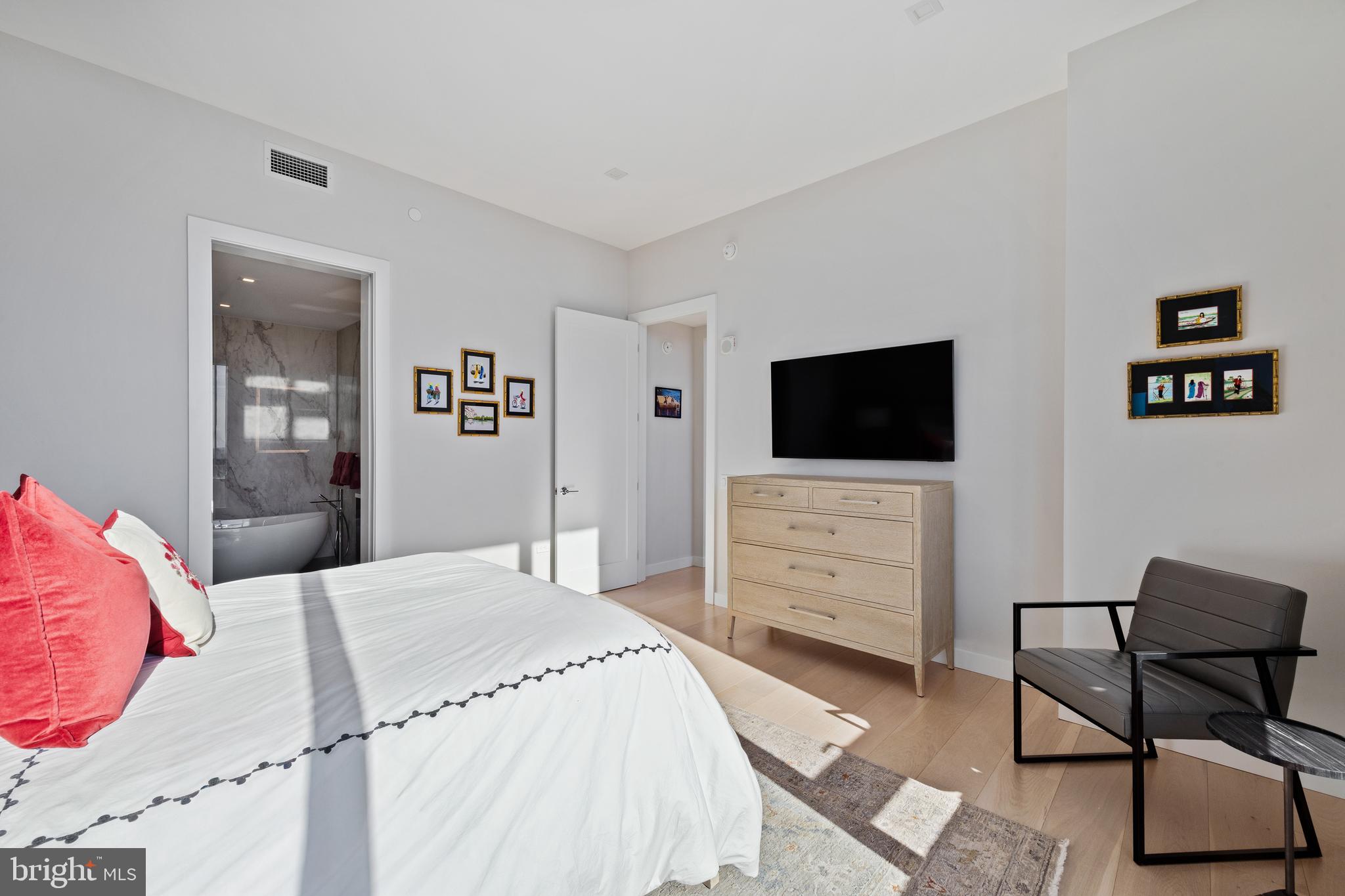 1911 Walnut Street, Unit 3301 Philadelphia, PA 19103 - Photo 17 of 50 a bedroom with a bed and a flat screen tv