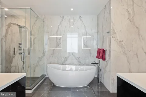 a bathroom with a bathtub and shower
