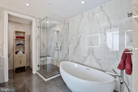 a bathroom with a bathtub and a shower