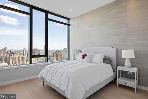 a bedroom with a large bed and a large window