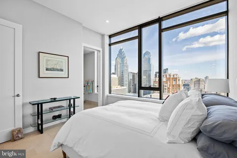 a bedroom with a large bed and a large window