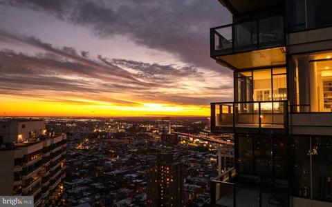 a view of a building and trees in the background