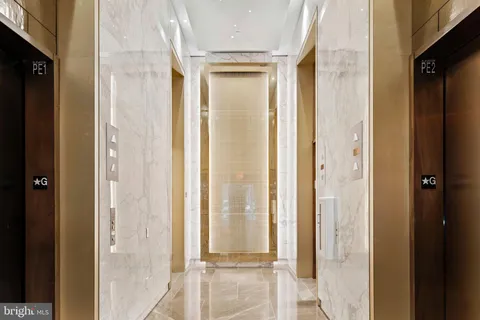 a living room with furniture and large windows