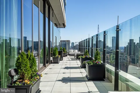 a living room with furniture and large windows