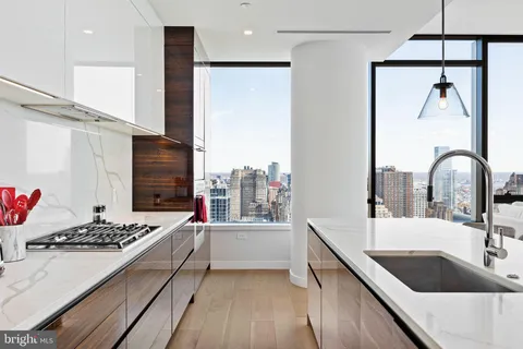 a kitchen with a sink stove and refrigerator