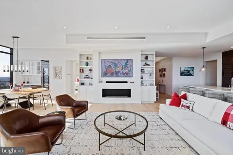 a living room with furniture kitchen view and a rug