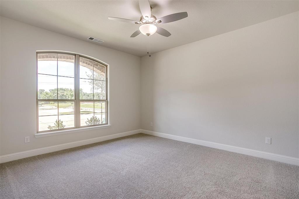 6819 Robert Reed Drive Arlington, TX 76001 - Photo 16 of 32 an empty room with a window and a fan