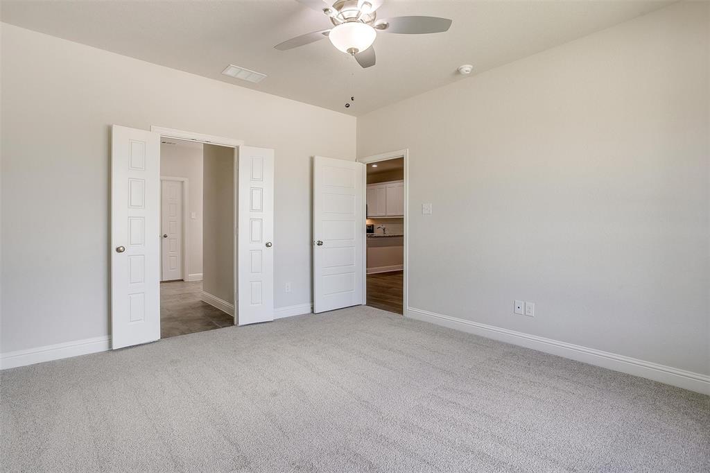 6819 Robert Reed Drive Arlington, TX 76001 - Photo 18 of 32 an empty room with closet and a ceiling fan