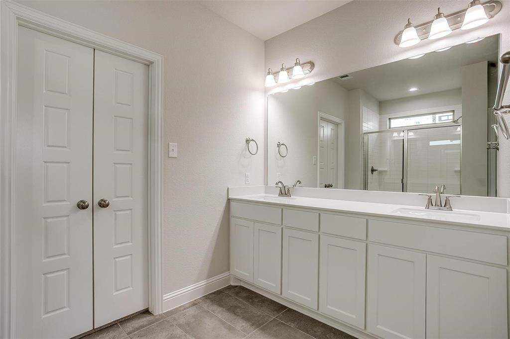 6819 Robert Reed Drive Arlington, TX 76001 - Photo 20 of 32 a spacious bathroom with a double vanity sink and a mirror