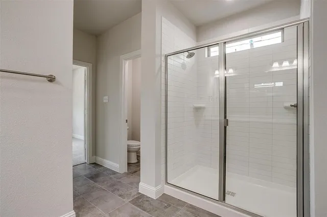 a bathroom with a glass shower door