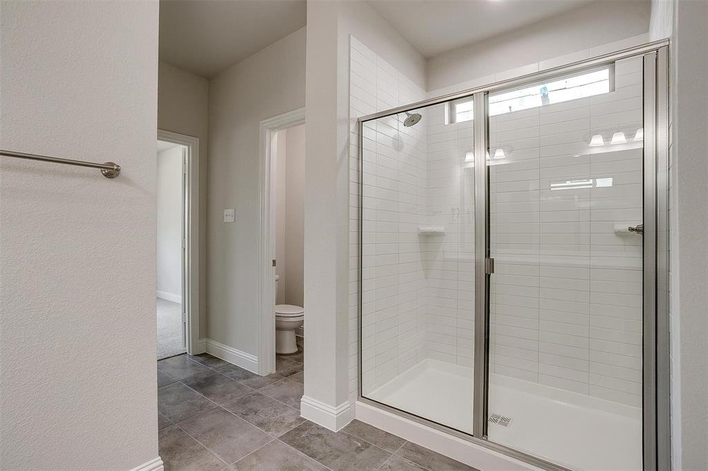 6819 Robert Reed Drive Arlington, TX 76001 - Photo 21 of 32 a bathroom with a glass shower door