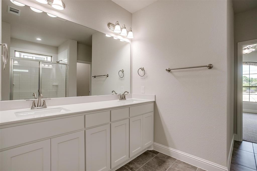 6819 Robert Reed Drive Arlington, TX 76001 - Photo 22 of 32 a bathroom with a double vanity sink and a mirror