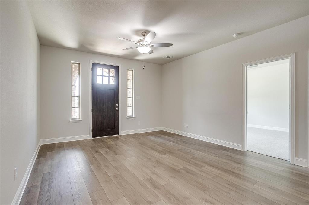 6819 Robert Reed Drive Arlington, TX 76001 - Photo 5 of 32 a view of an empty room with wooden floor