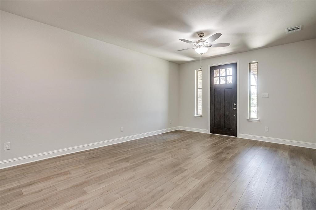 6819 Robert Reed Drive Arlington, TX 76001 - Photo 6 of 32 a view of an empty room with wooden floor