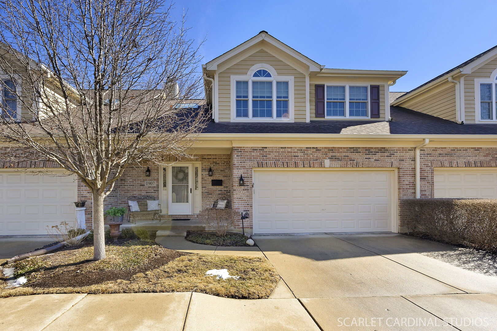 1907 Kingsbrook Court Wheaton, IL 60187 - Photo 1 of 29 a front view of a house with garden