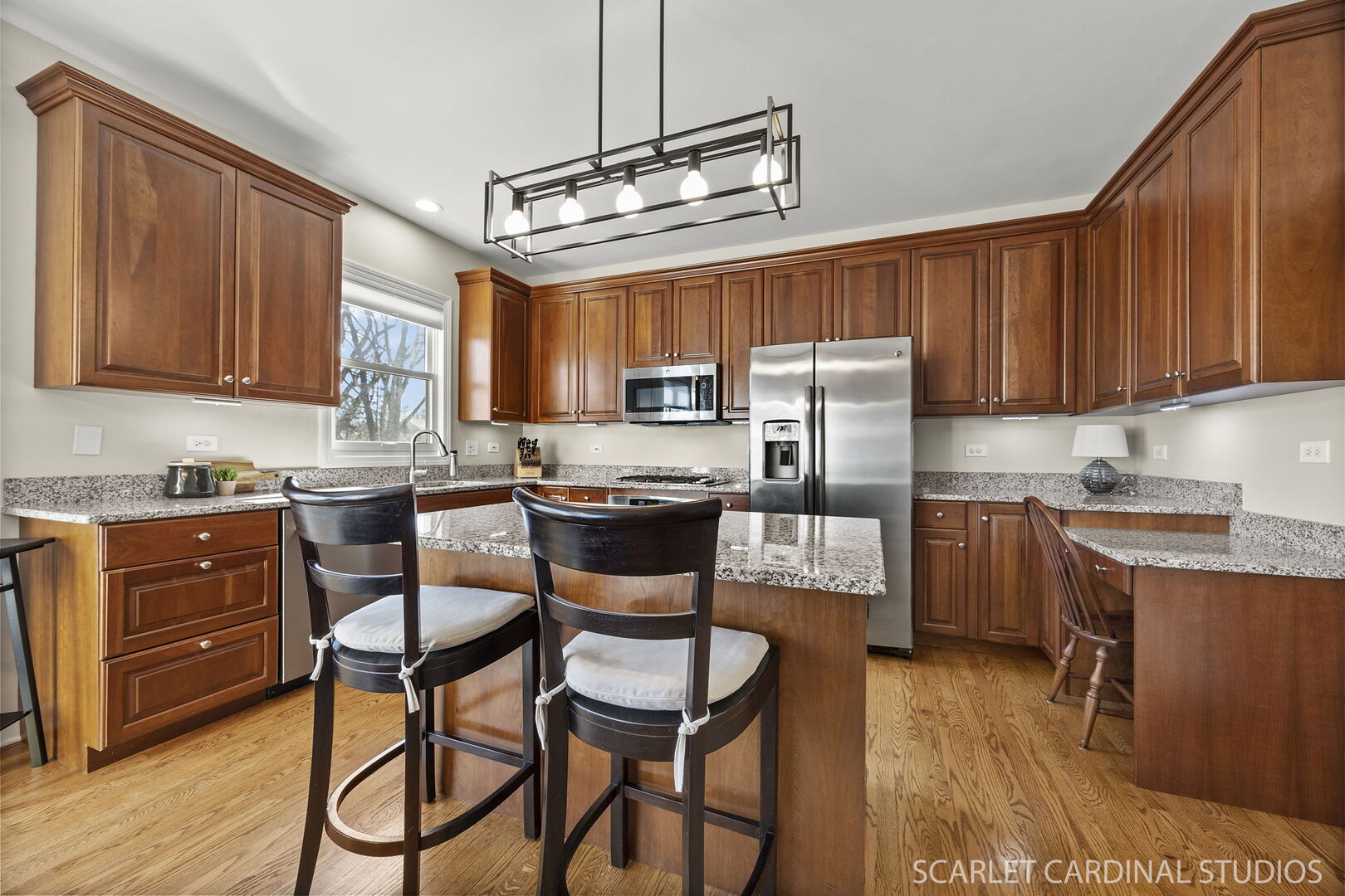1907 Kingsbrook Court Wheaton, IL 60187 - Photo 8 of 29 a kitchen with granite countertop wooden cabinets and stainless steel appliances