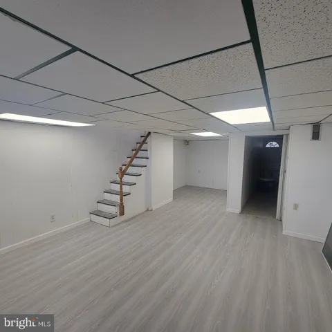 a view of a room with wooden floor and white walls