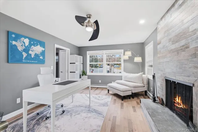 a living room with furniture a flat screen tv and a large window
