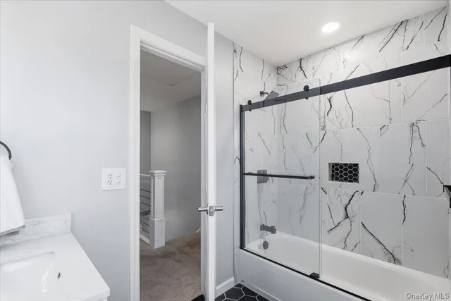 a spacious bedroom with a bed a couch and a window