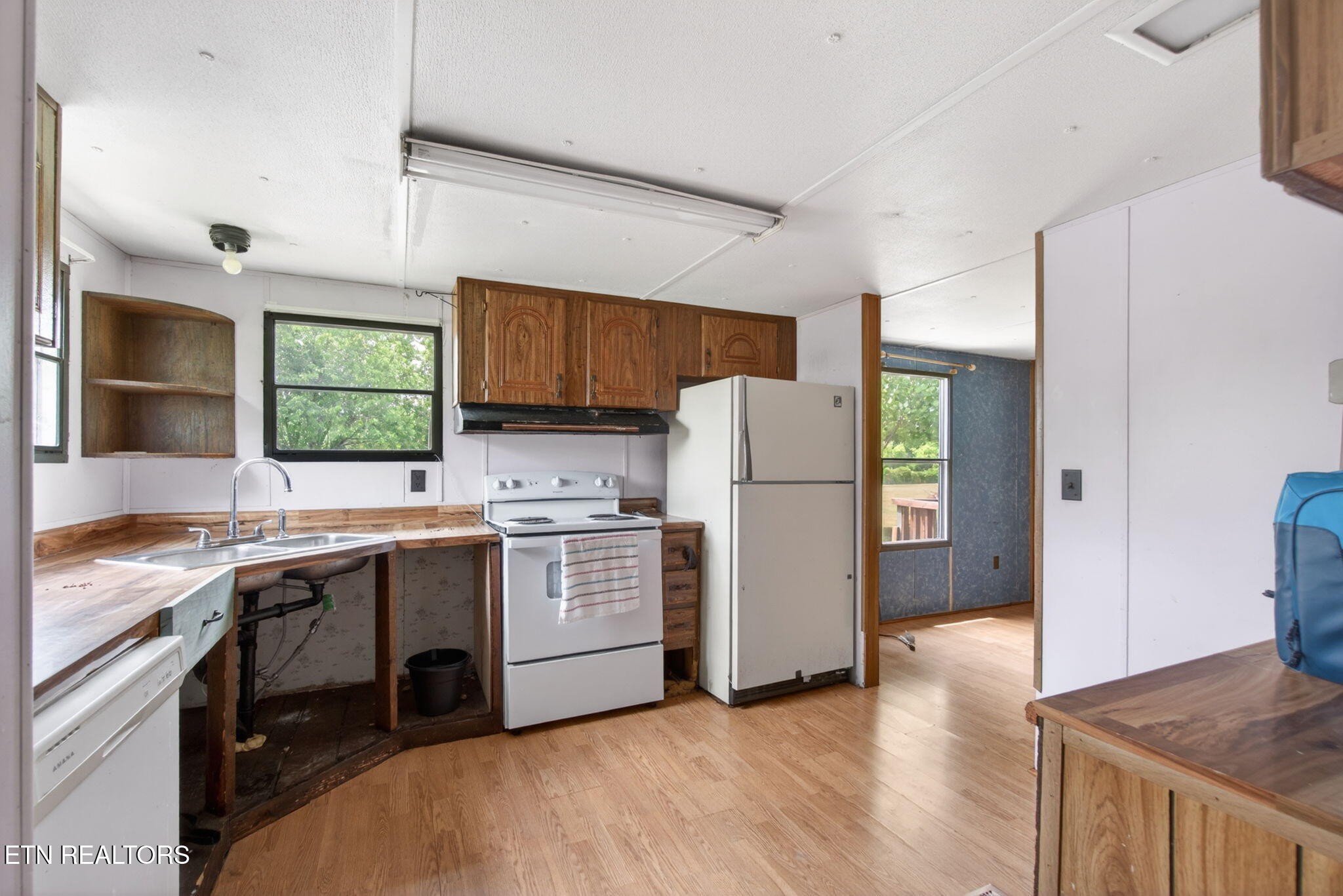 259 Freewill Ridge Road Gainesboro, TN 38562 - Photo 29 of 36 a kitchen with a sink a refrigerator and a stove top oven