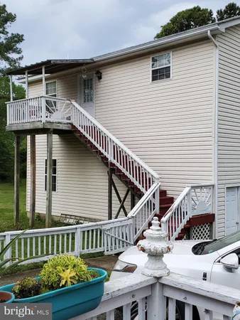 a view of a house with wooden deck