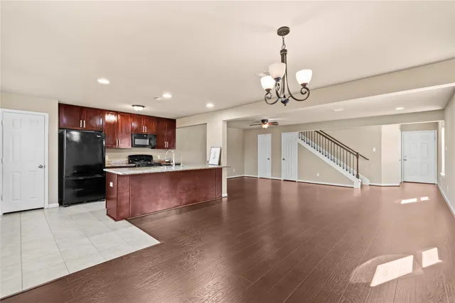 a view of an empty room and a ceiling fan