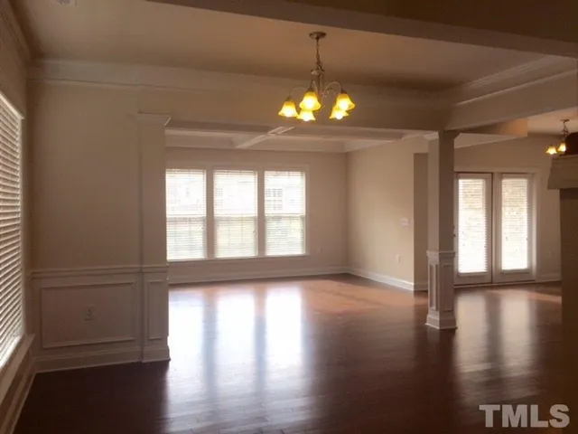 a view of a livingroom with hardwood floor and a ceiling fan