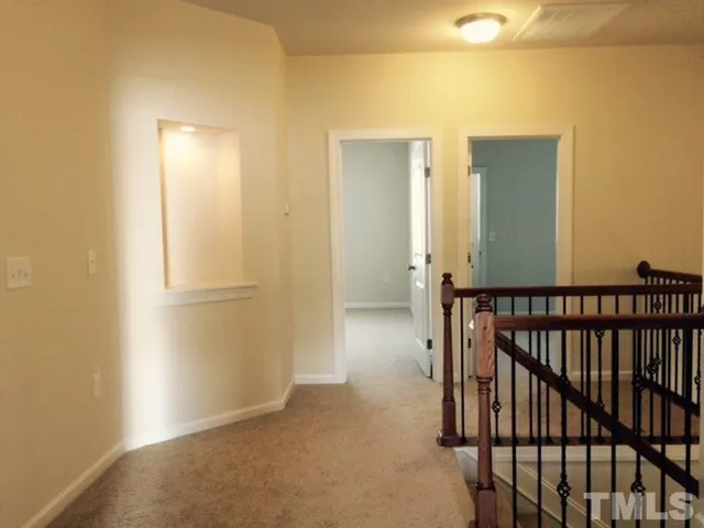 a view of hallway with bathroom