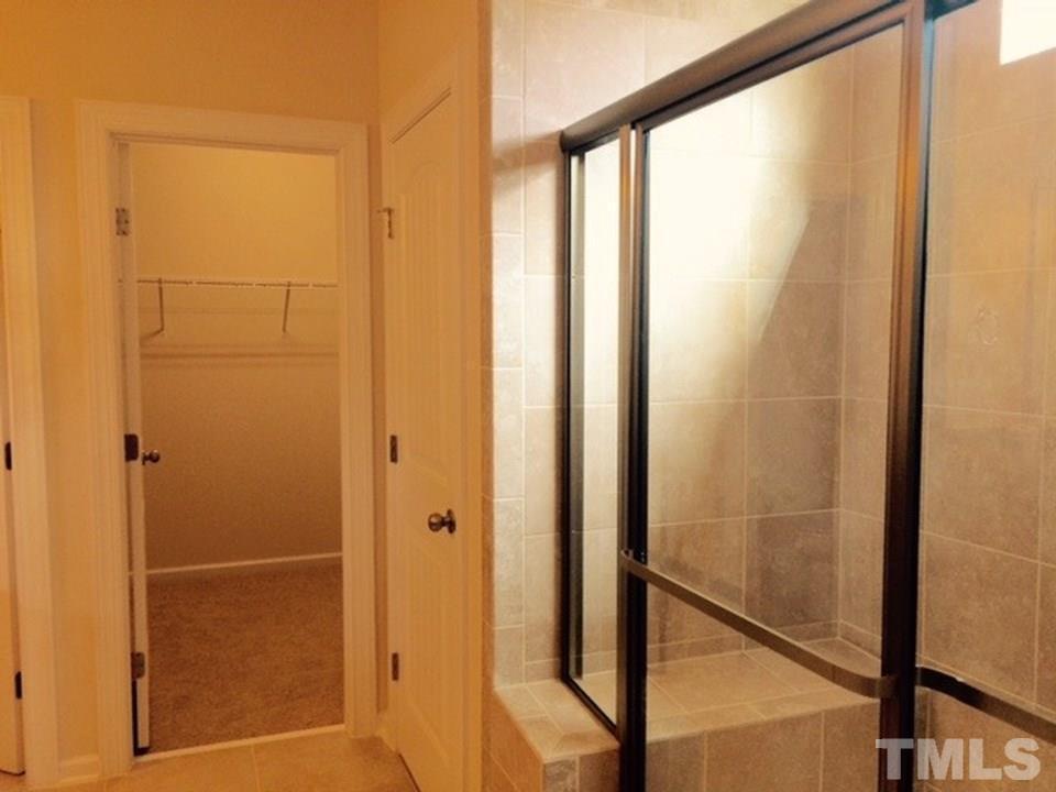 403 Bent Tree Lane Cary, NC 27519 - Photo 9 of 13 a bathroom with a glass shower door