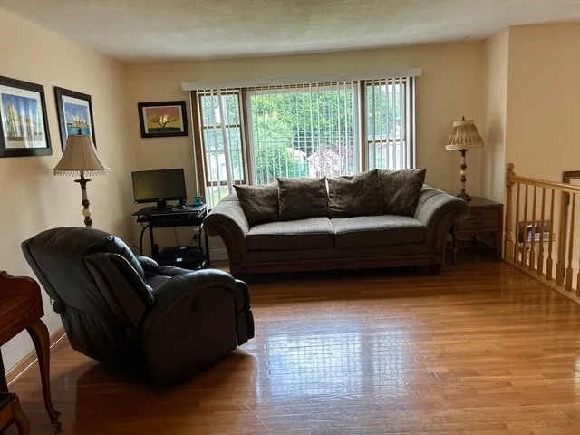 a living room with furniture window and wooden floor