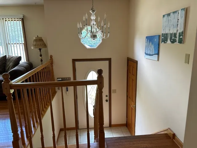 a view of a hallway with wooden floor and staircase