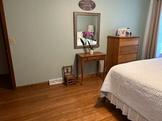 a bed room with a bed and a desk