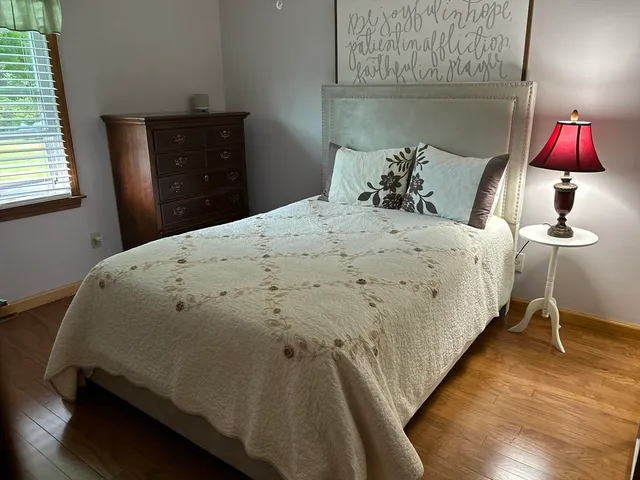 a bedroom with a bed and a window