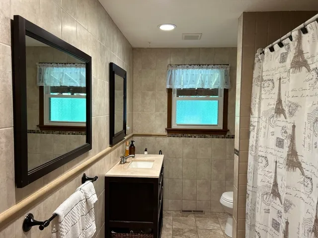a bathroom with a shower and a mirror