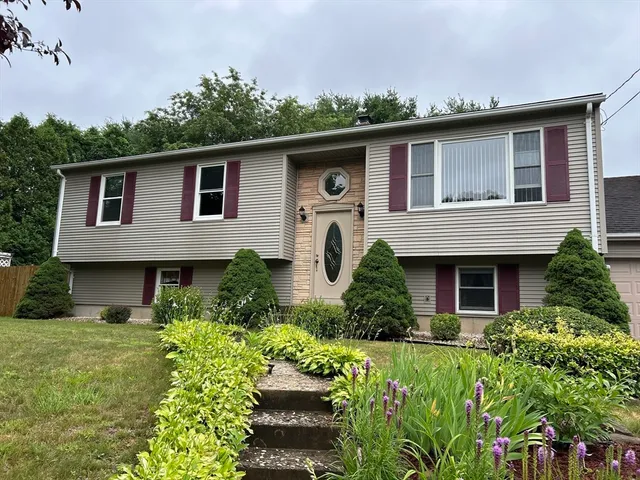 a front view of a house with a garden
