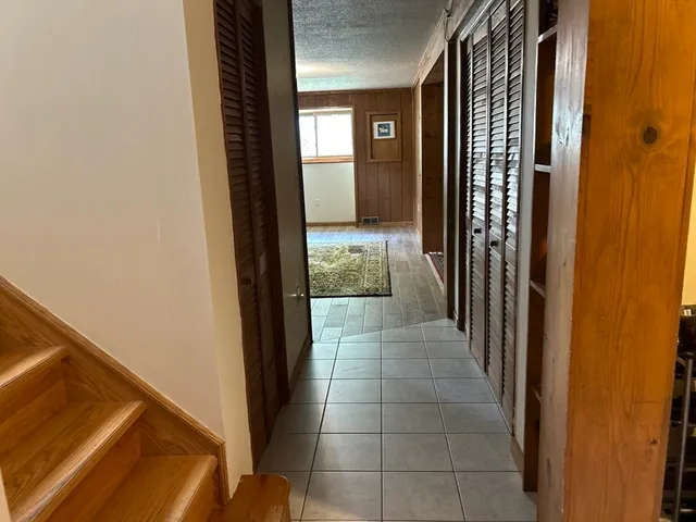 a room with a mirror and cabinets