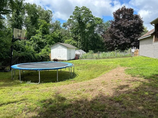a backyard of a house with table and chairs