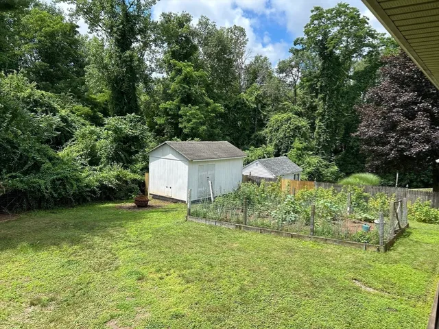 a view of a house with a backyard