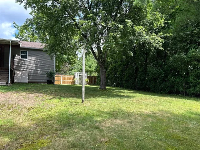 a front view of house with a garden