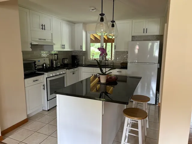 a kitchen with a sink a stove and a refrigerator